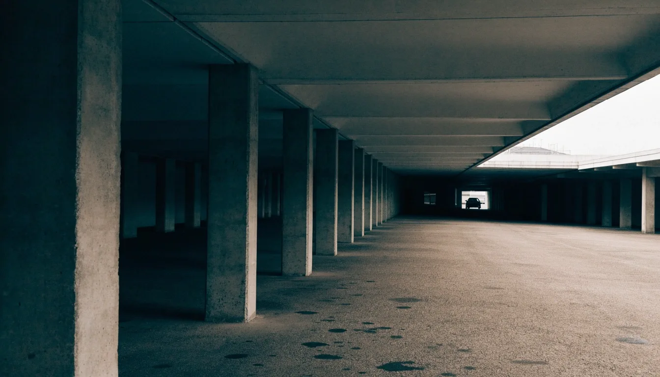 Painted concrete column and ceiling detail inside an undercover airport parking deck